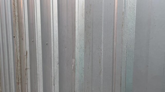 Abstract vertical pattern of modern galvalum wall with light flare