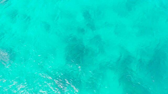 Transparent turquoise sea water, natural background. The surface of sea water in a tropical lagoon. Summer and travel vacation concept.