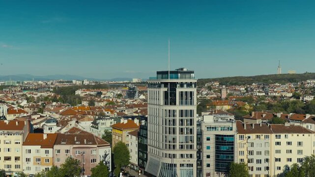 Centered View of Modern High Rise Building in Sofia City Center with TV Tower in Background Under Blue Sky