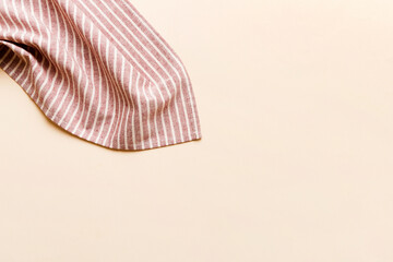 Naklejka premium top view with red empty kitchen napkin isolated on table background. Folded cloth for mockup with copy space, Flat lay. Minimal style