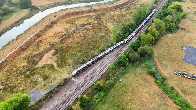 Overhead aerial pan documents the railway accident site after a passenger train carrying around 150 people derailed near Lewes, East Sussex, United Kingdom, August 2026.
