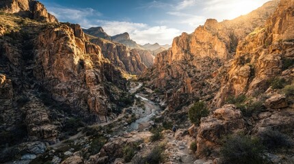 Naklejka premium Dramatic Rocky Canyon Landscape with Winding River and Mountain Hiking Trail