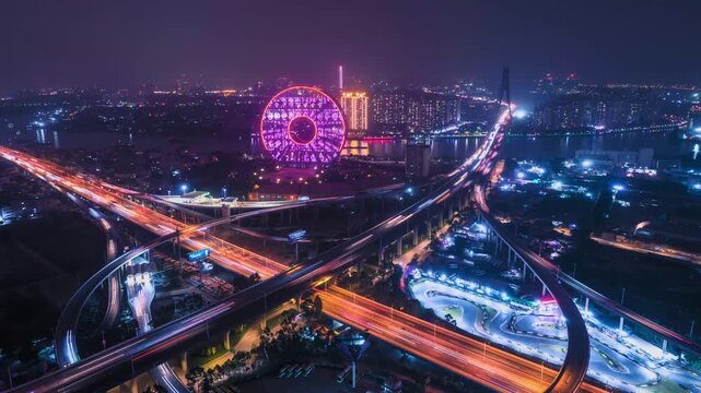 Drone hyperlapse of the iconic circular Guangzhou Yuan skyscraper under blue sky, Guangzhou, China.
