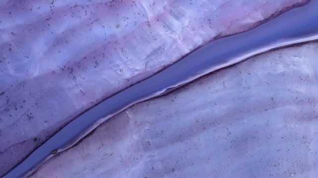 Mixing different colored alcohol inks with epoxy resin in a close-up view
