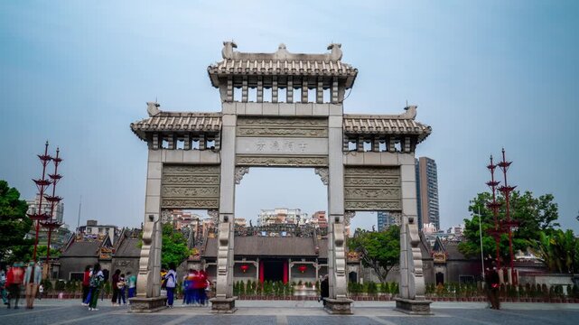 Daytime timelapse of the entrance archway and traditional architecture of the Chen Clan Ancestral Hall in Guangzhou, China. A historic Cantonese cultural landmark featuring ornate decorations and a di