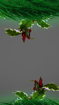 Decorative with spruce branches, holly and red berries against grey background