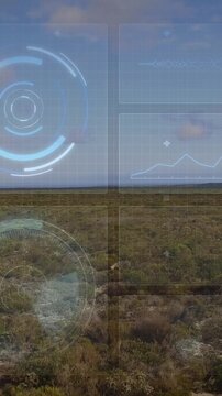 Animating digital interface with data charts and graphs over aerial landscape view