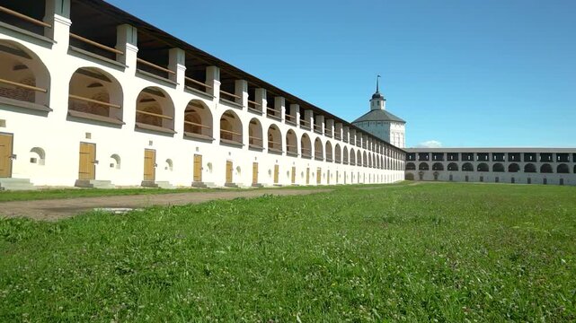Panoramic view of Kirillo-Belozersky Monastery with medieval stone walls and old monastic cells. Camera moves from left to right on a clear sunny day.