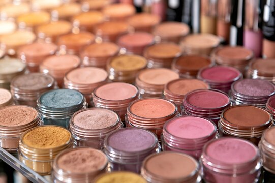 Cosmetic jars displaying colorful powdered eyeshadow and makeup