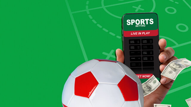 Placing bets on a soccer game using a mobile app while holding cash and a soccer ball