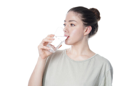 Woman drinking a glass of tap water as hydration and healthy lifestyle concept, isolated on white background