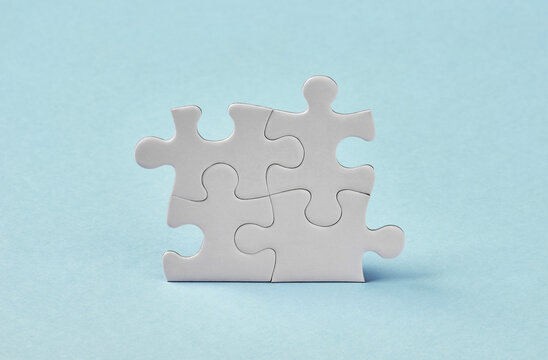 Connected puzzle pieces on blue background