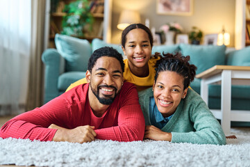 Obraz premium Portrait of mother, father and daughter having fun at home, family life, parenting, love and bonding concepts