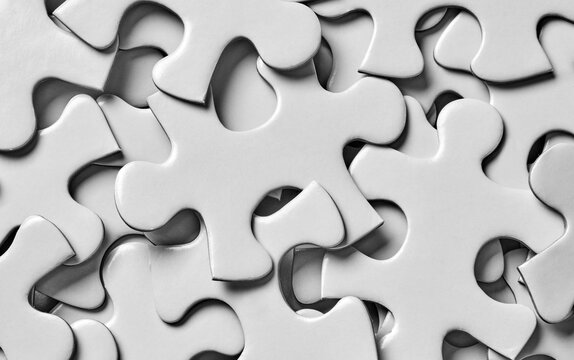 Close up of white jigsaw puzzle pieces
