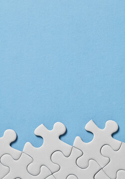 Puzzle pieces along bottom on blue background