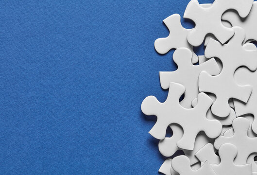 White puzzle pieces on blue background