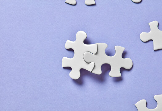 Interlocking puzzle pieces on purple background