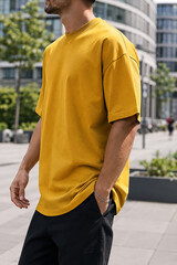 Obraz premium Mustard Yellow Oversized T-Shirt on Male Model in Urban Setting, Generative AI
