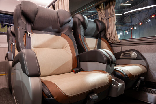 Marcopolo bus interior featuring spacious reclining seats, premium leather upholstery, seat belts, armrests and modern passenger amenities.