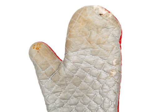 Old worn oven mitt with stains and weathered fabric isolated on white.