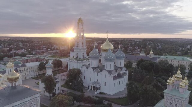 Aerial approach to historic domes under sunset, D-Log