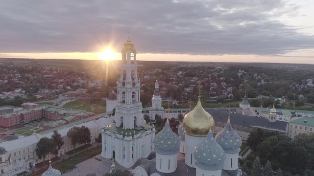 Aerial glide over historic domes under sunset, D-Log