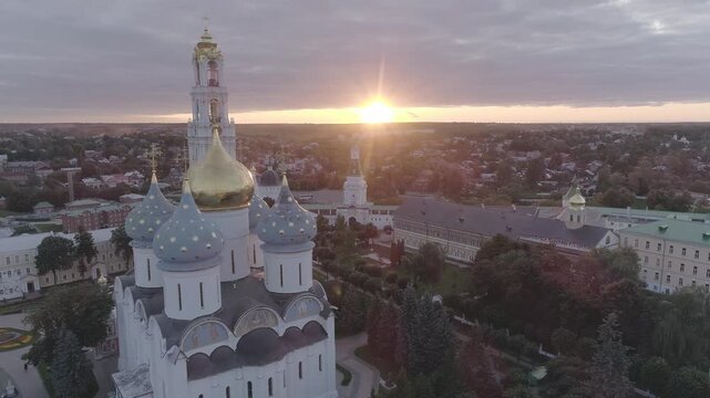 Aerial pass over historic domes under sunset, D-Log