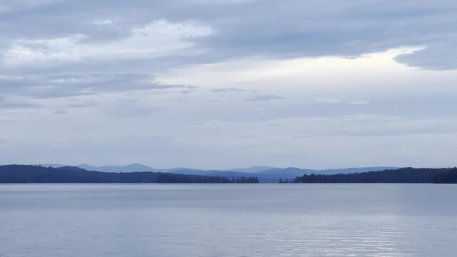 Calm Blue Serene Lake Scene with Distant Mountains