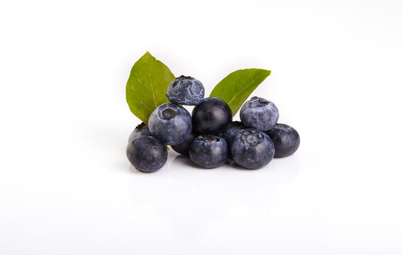 Fresh blueberry with green leaves isolated on white background