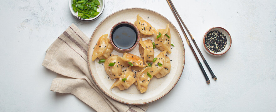 Gyoza dumplings soy sauce chopsticks asian Japanese food wontons