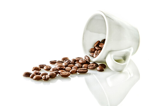 Coffee beans in a cup of coffee isolated on white background.