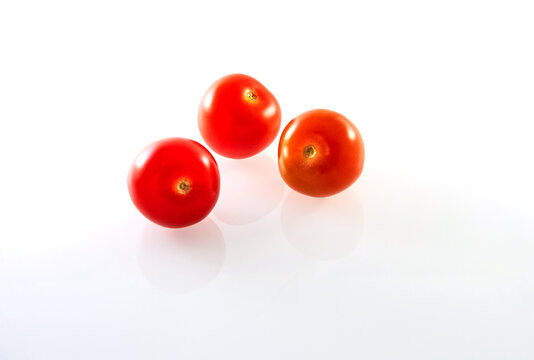 Three Cherry tomatoes isolated on white background