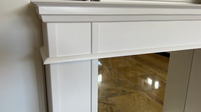 4K 16:9 horizontal video smoothly moving in towards a custom handcrafted white spruce wooden fireplace mantle. 