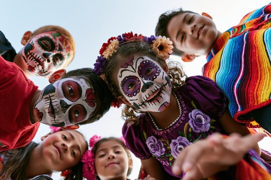 Portrait of children with sugar skull face paint during day of the dead celebration. Smiling Children in Colorful Sugar Skull Makeup Celebrating Day of the Dead