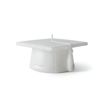A white graduation cap candle shaped like a mortarboard for education celebration