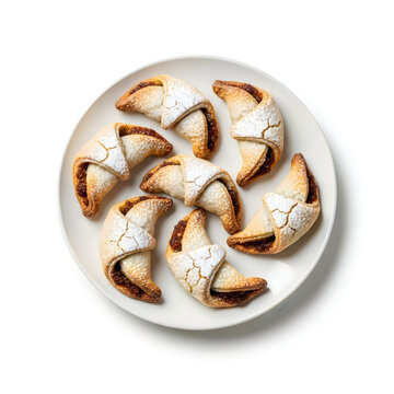 Top view of delicious sweet cannoli dessert pastries arranged on a round white plate