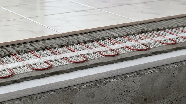 Electric underfloor heating mat installation under ceramic tile. Warm floor system cross section with heating cable and insulation layer. Energy efficient home heating technology