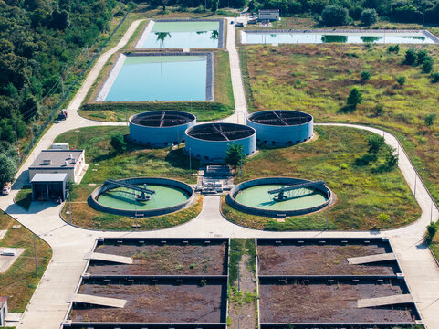 Aerial view of the Telavi Waste Water Treatment Facility featuring circular sedimentation tanks and rectangular treatment basins surrounded by greenery in Kondoli, Kakheti, Georgia.