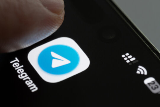 Finger press Telegram app icon