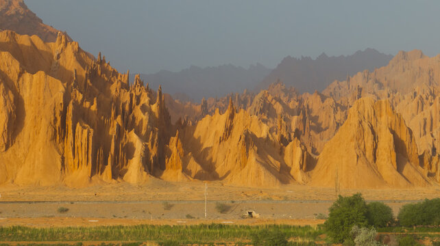 Golden Eroded Desert Mountains and Arid Valley