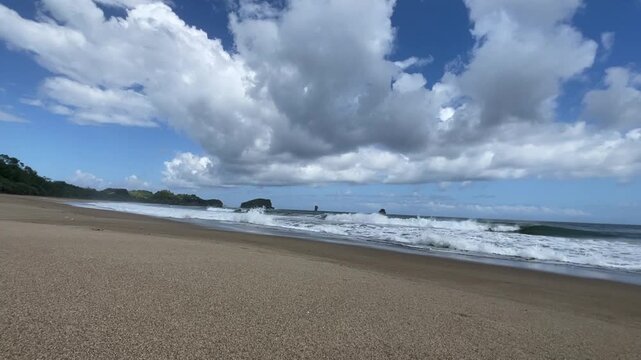 Static tripod ocean waves rolling onto sandy beach tropical nature
