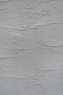 Plaster wall background. Grey abstract background. Plaster wall texture. Texture of gray decorative plaster or concrete. Abstract grunge background design. Gray cement plaster texture. Concrete stone