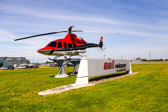 Mirabel, Quebec, Canada, May 20, 2026 - Bell Helicopter (Bell Textron Canada) sign and C-BH 86 rotorcraft in front of the plant located north of Montreal
