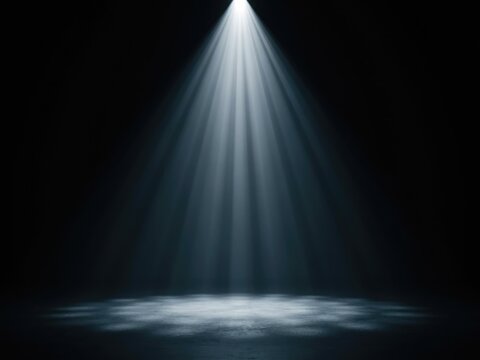 Bright white spotlight beam shining down on a dark empty floor