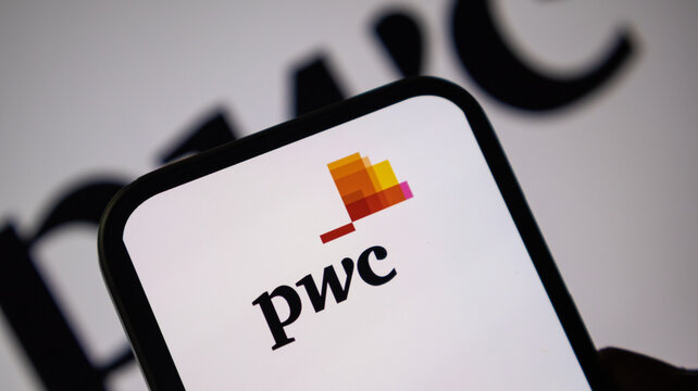 PwC logo displayed on a smartphone screen with blurry background.