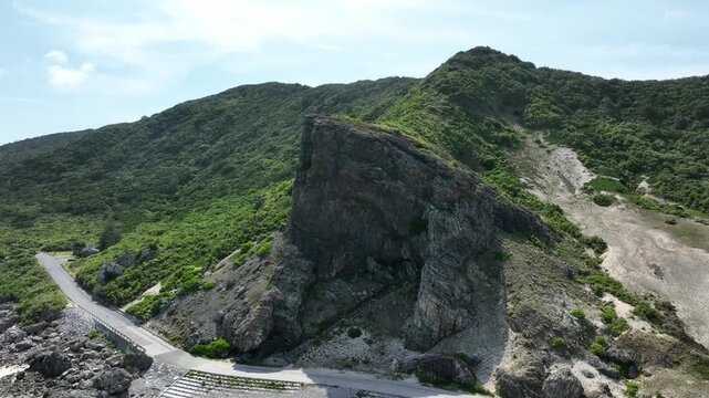 Aerial drone shot of Kumaya Cave on Iheya Island, Okinawa. A sacred power spot and legendary site of the Japanese 'Amano-Iwato' myth.