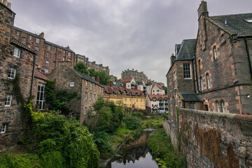 Fototapeta premium Picturesque historic stone houses of Dean Village along the peaceful Water of Leith river in Edinburgh, Scotland