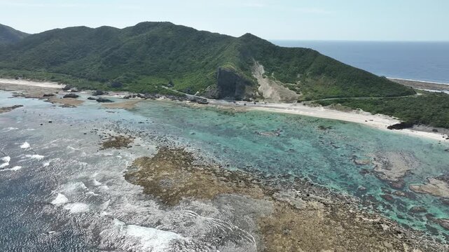 Aerial drone shot of Kumaya Cave on Iheya Island, Okinawa. A sacred power spot and legendary site of the Japanese 'Amano-Iwato' myth.⁠
