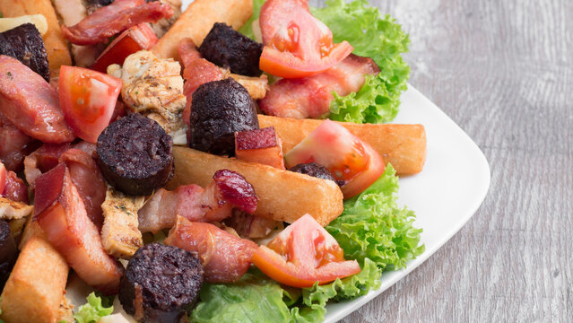 Colombian picada platter serving blood sausage and meat