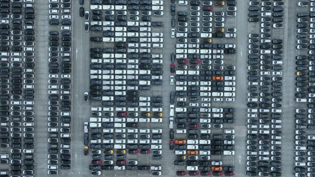 This EV car awaits shipping. Each EV car gets loaded. The EV car goes overseas.